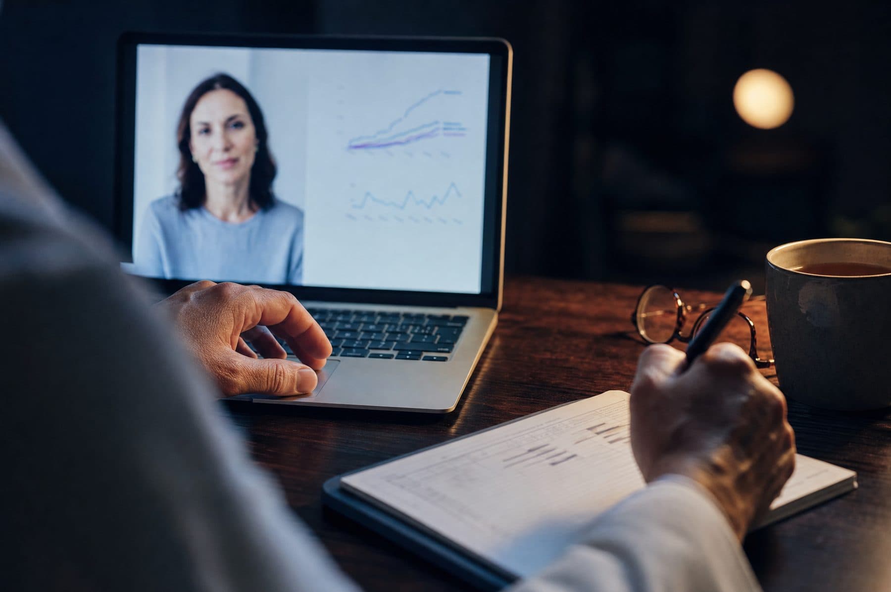 A person reviewing their health information with a clinician on a laptop at home.